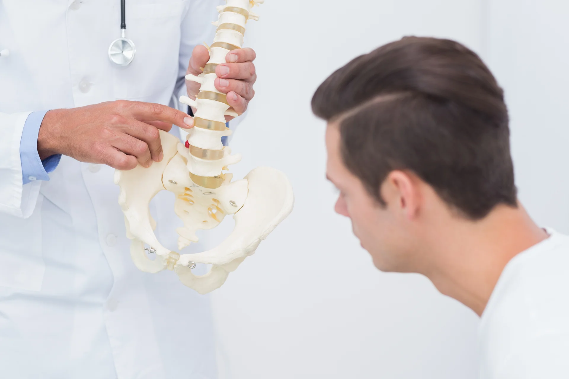 doctor explains spine anatomy to his patient