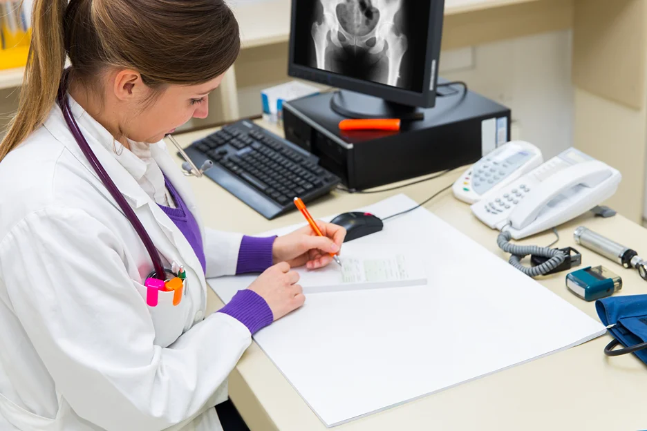 doctor checking her patient's record