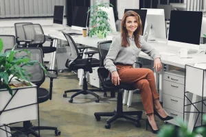 woman sitting in an ergonomic chair inside the office