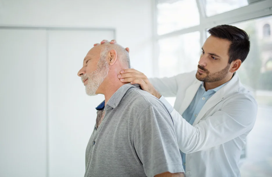 doctor examines patient's neck