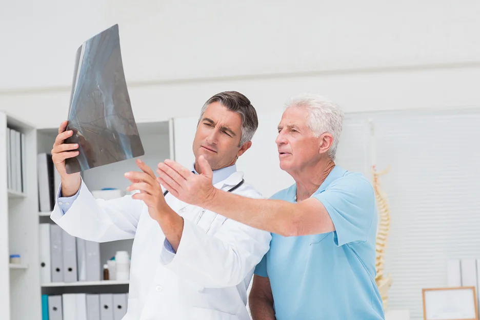 doctor shows x-ray results to patient and diagnosis for low back pain