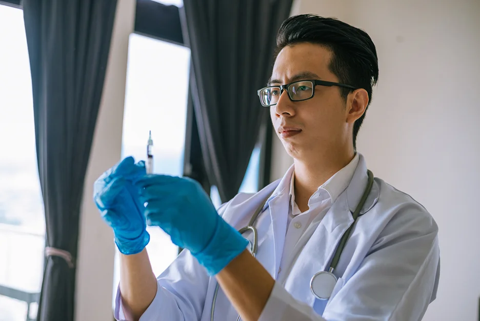 doctor holding syringe