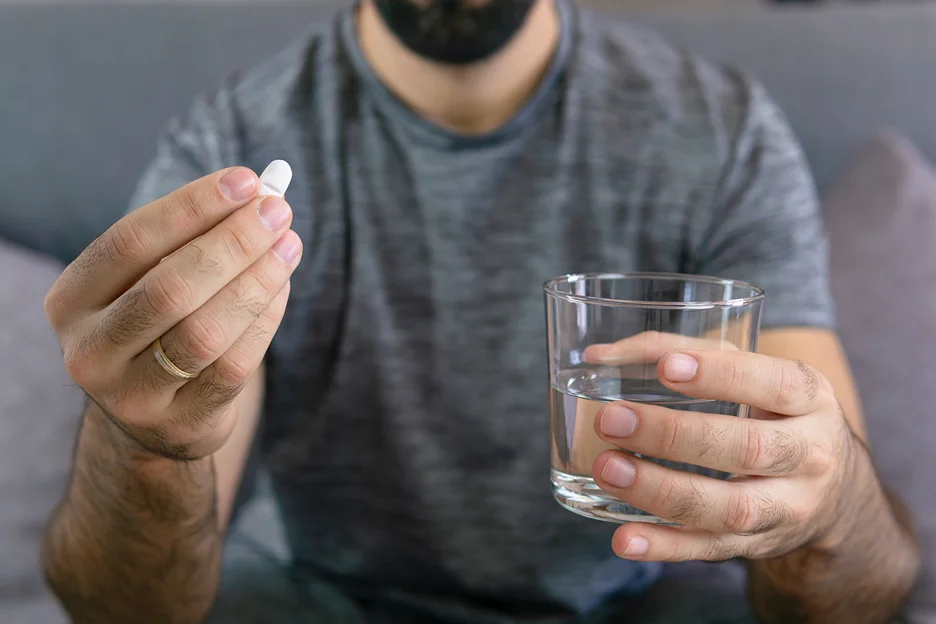 man taking a pill