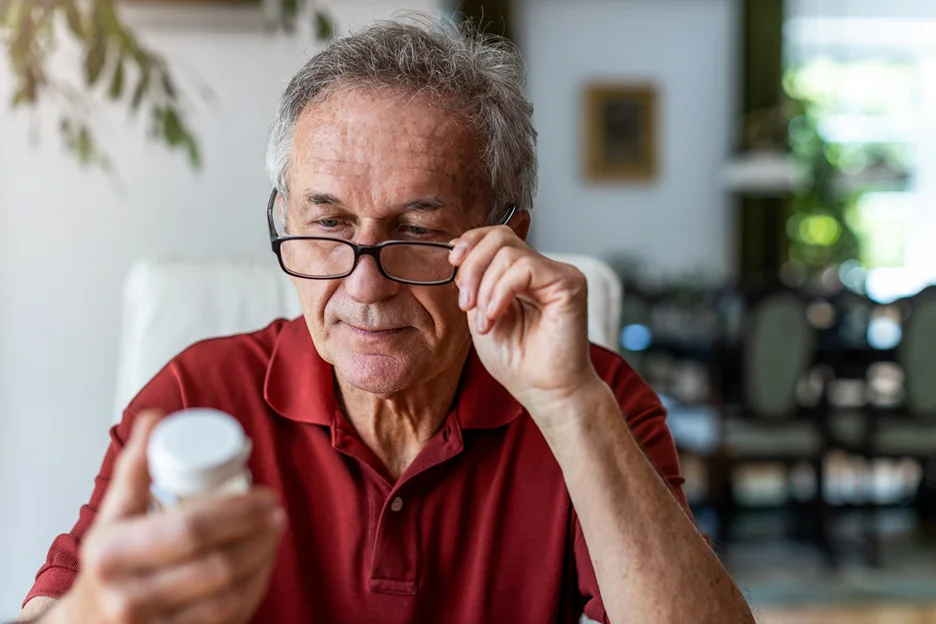 senior man taking pain medication