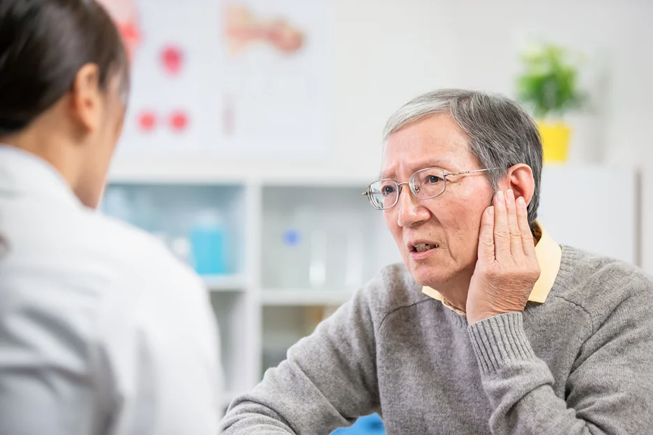 a senior man complains his symptoms to his doctor