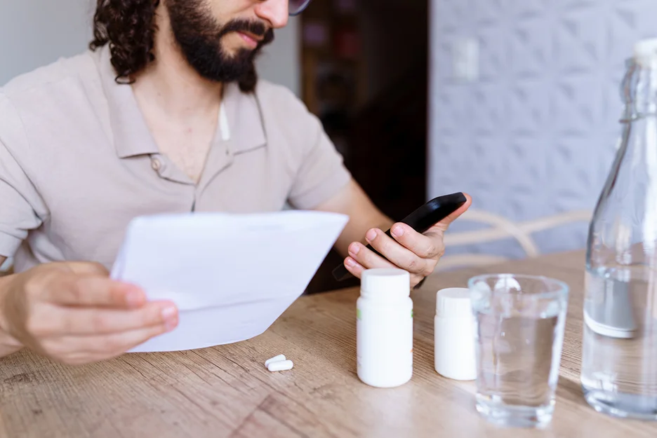 a man checks his medications for upper back pain