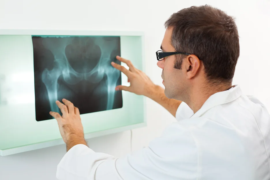 doctor examines patient's x-ray result
