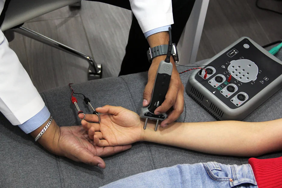 doctor perform electromyography test on the patient