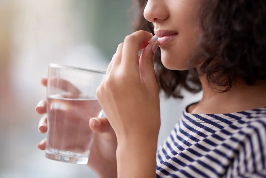 woman taking a pill