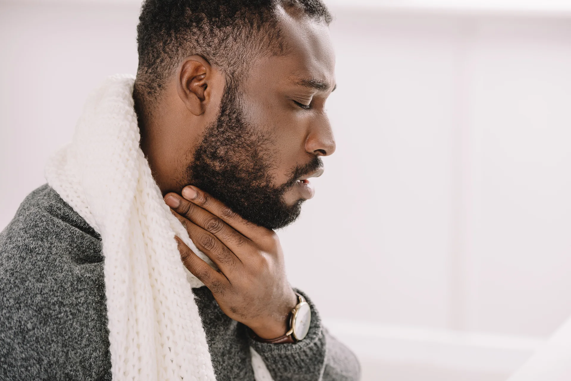 man suffering from sore throat