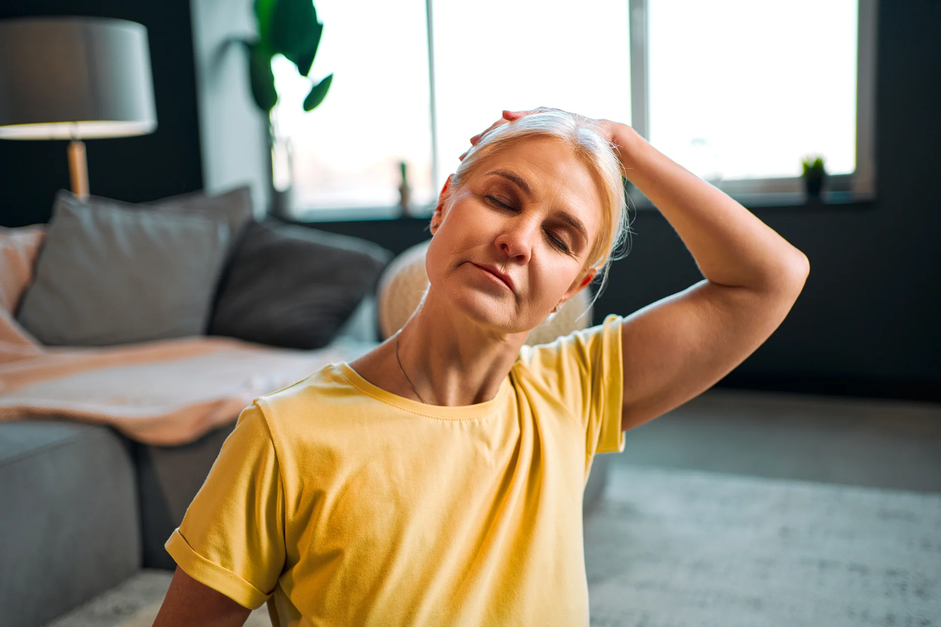 mature woman does neck stretching