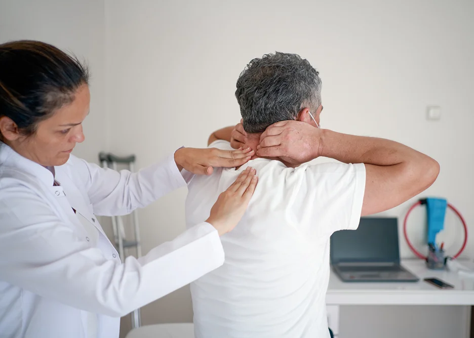 female doctor examines the patient's neck