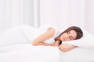 a woman sleeping soundly on the bed