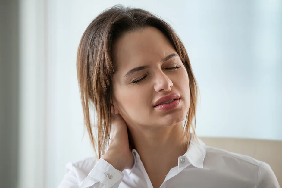 a woman suffering from chronic neck pain