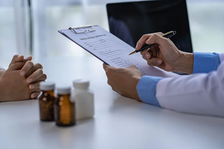 a doctor gives prescription to his patient