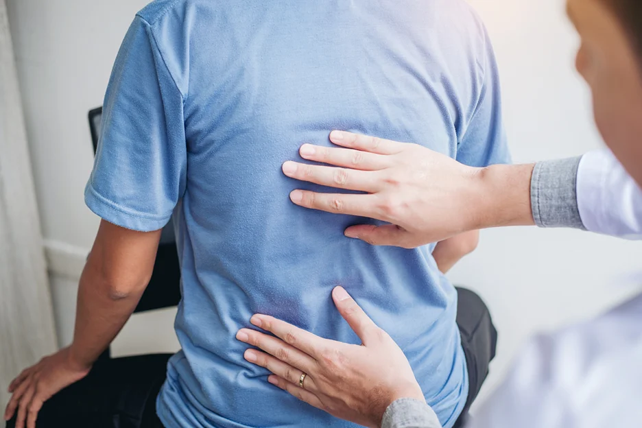 a doctor examines the patient's back