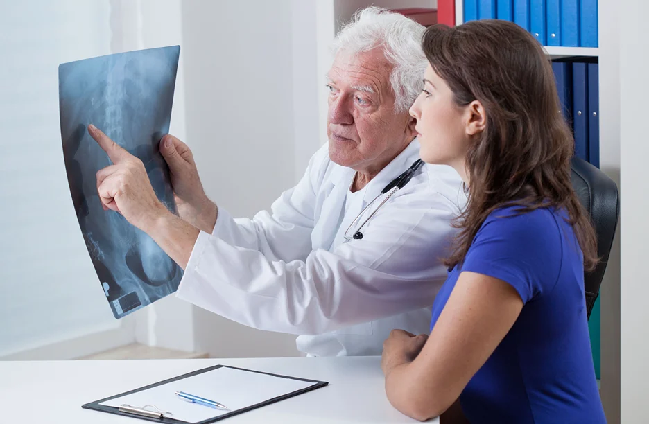 doctor shows x-ray result to his patient on upper back pain diagnosis