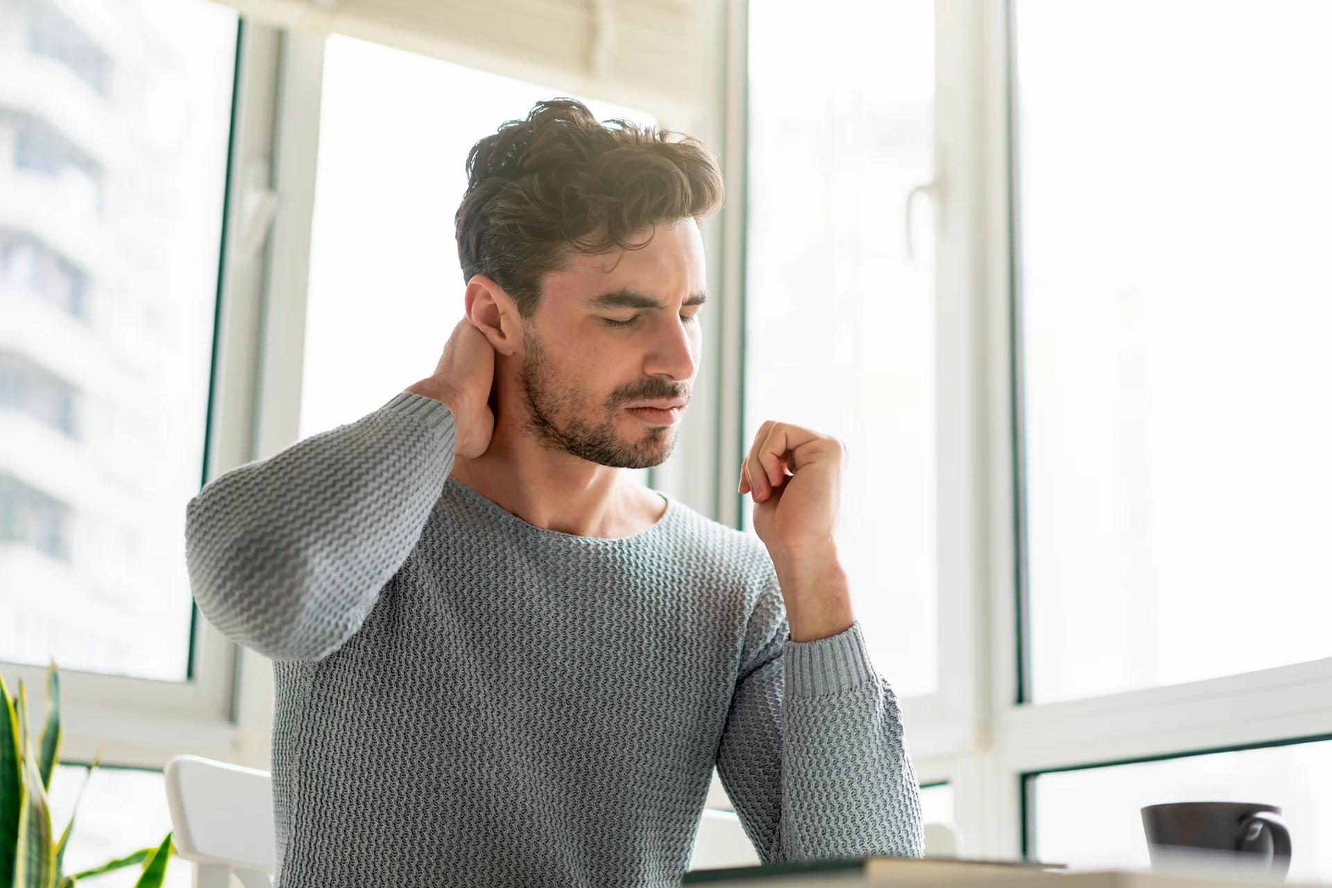 a man suffering from persistent neck pain