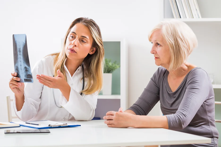 a doctor explains the x-ray result to the patient