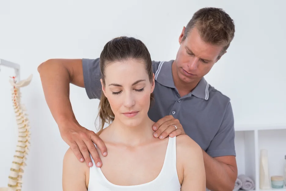 chiropractor performs spinal manipulation in his patient