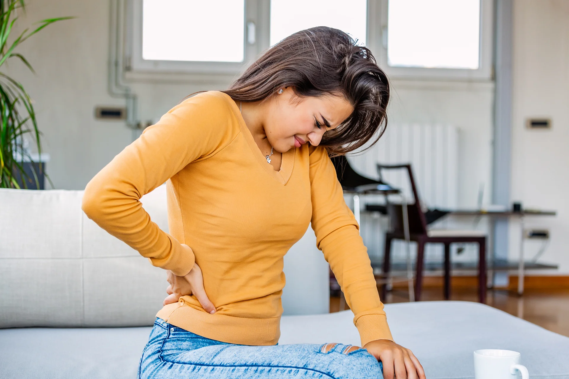 a woman suffers back pain