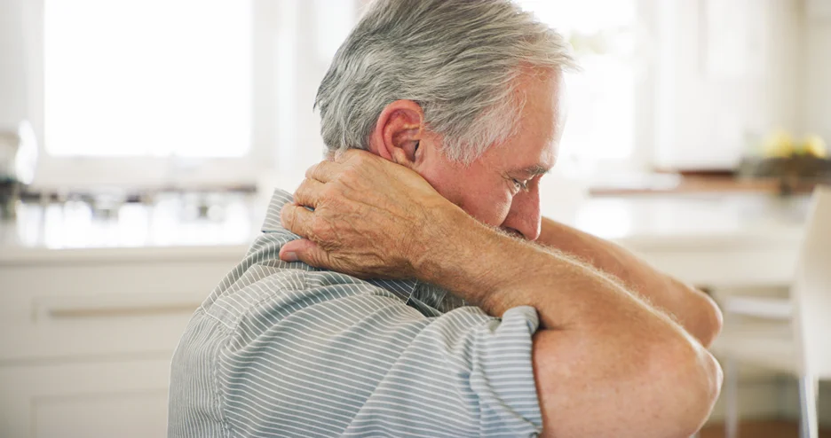 a matured man suffers from neck pain