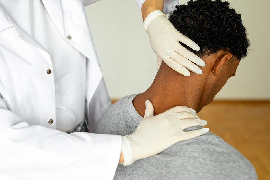 a doctor examines the patient's neck