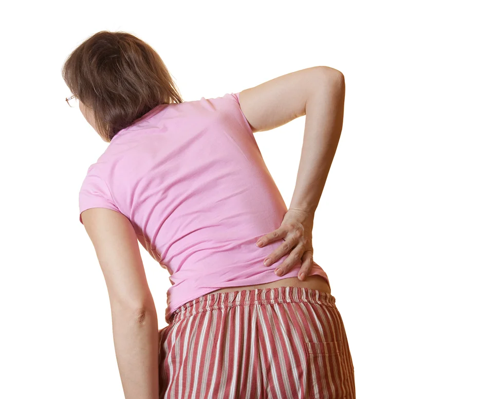 a woman suffering from lower back pain when bending over