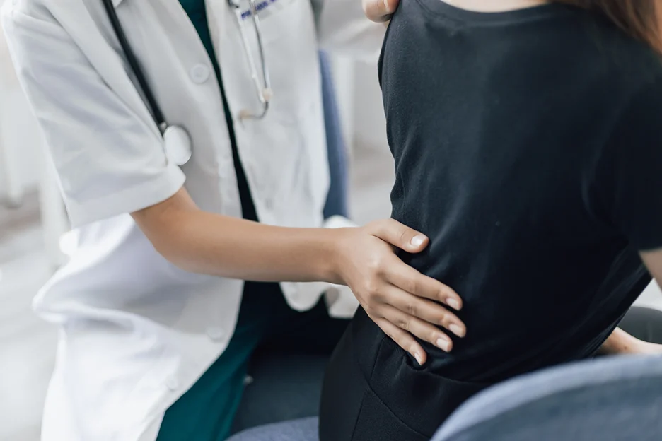 doctor and patient consultation on lower back pain when bending over
