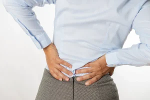 a woman suffers back pain during period