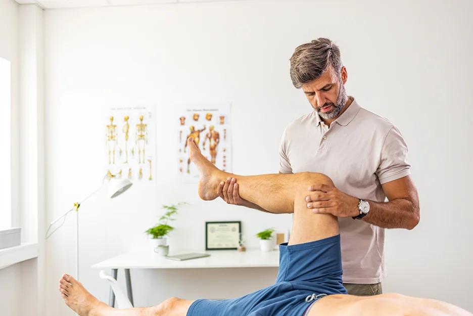 a physical therapist examines the patient's mobility after suffering from sciatica pain
