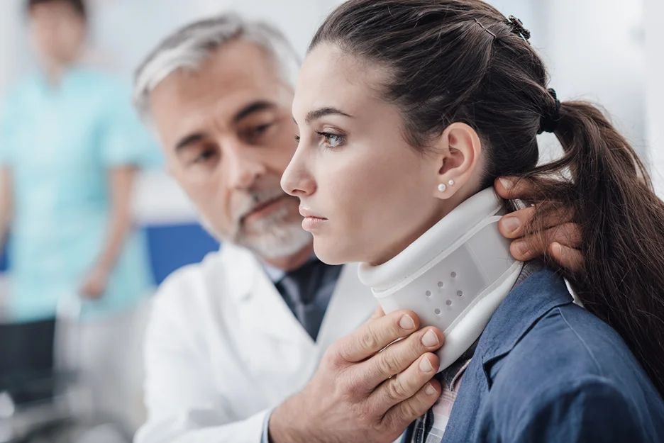 a doctor examines the patient's neck brace