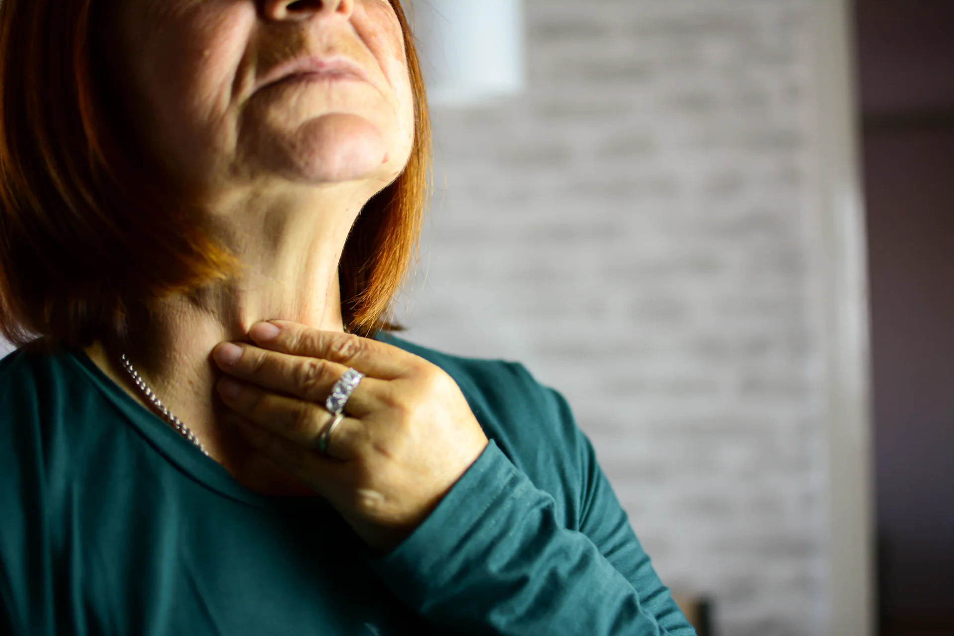 a woman suffers from neck pain