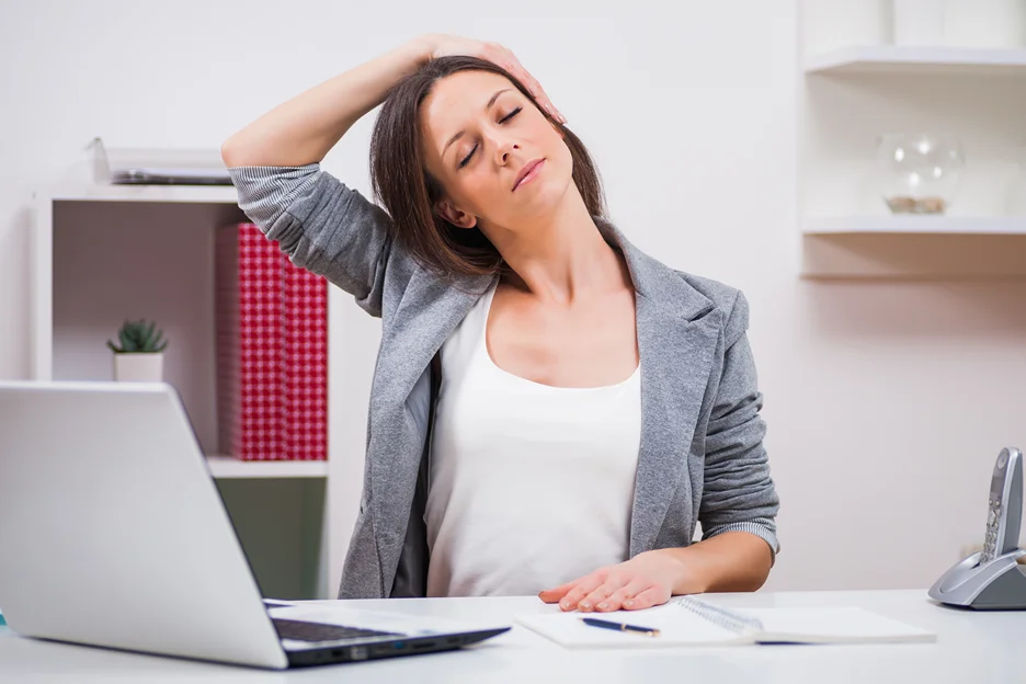 a woman doing neck stretches at work