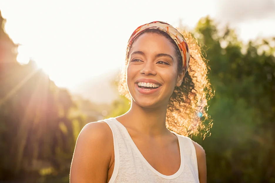 a portrait of a relaxed woman staying outdoor