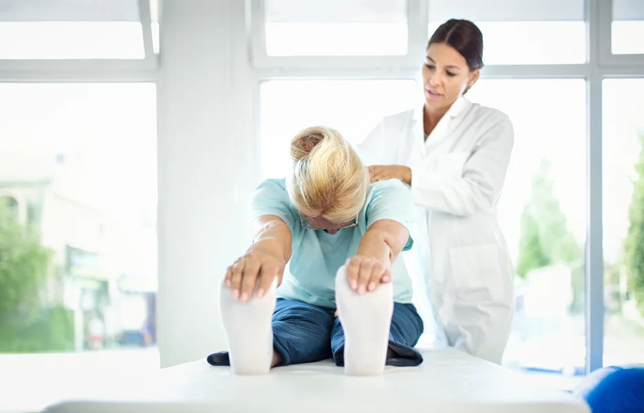 a doctor examines the patient's sciatica pain symptoms