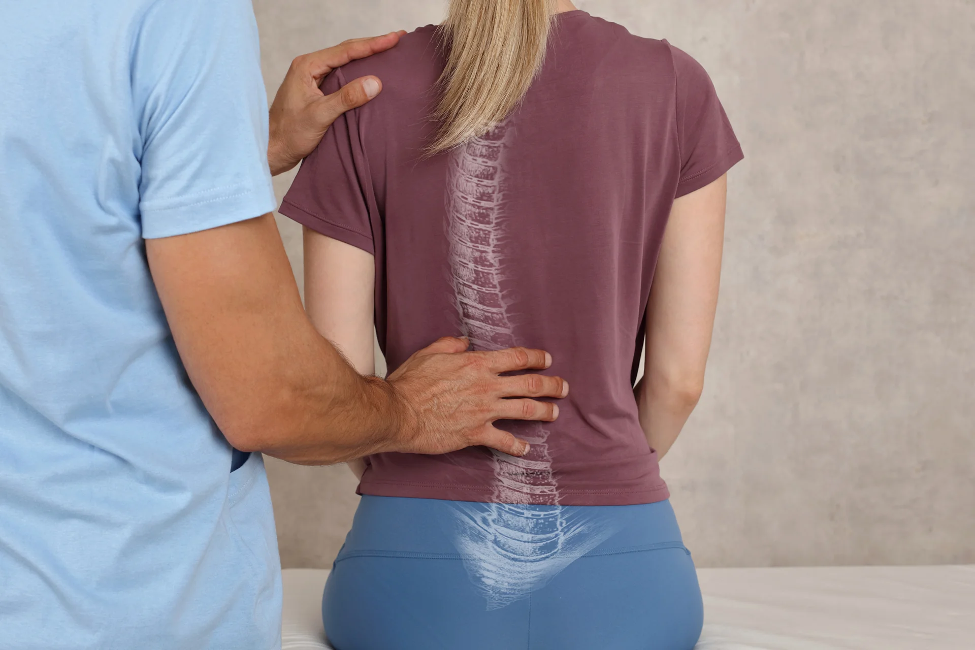 a doctor examines the patient's scoliosis condition