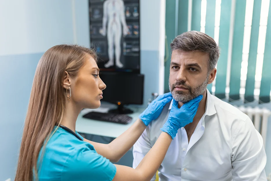 a doctor examines the patient's tmj and neck pain