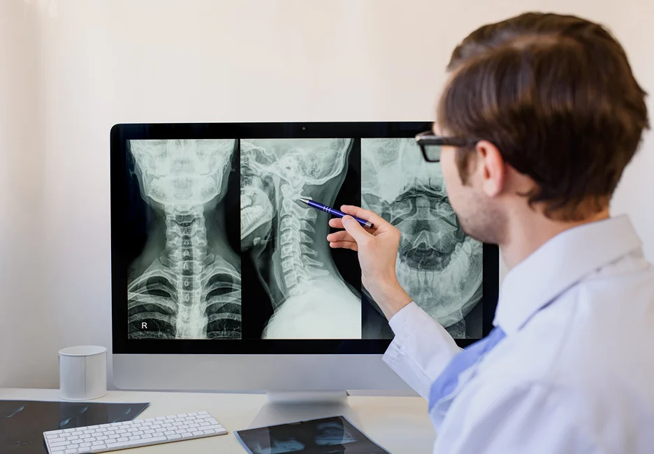 a doctor examines the neck x-ray results