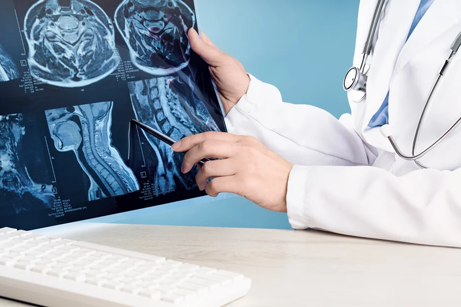 a doctor examines the MRI scan image of neck