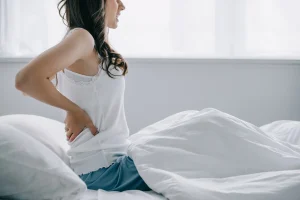 a woman suffering from back pain