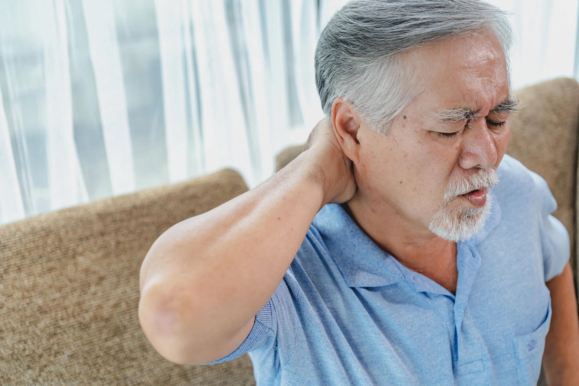 a senior man suffering from neck pain