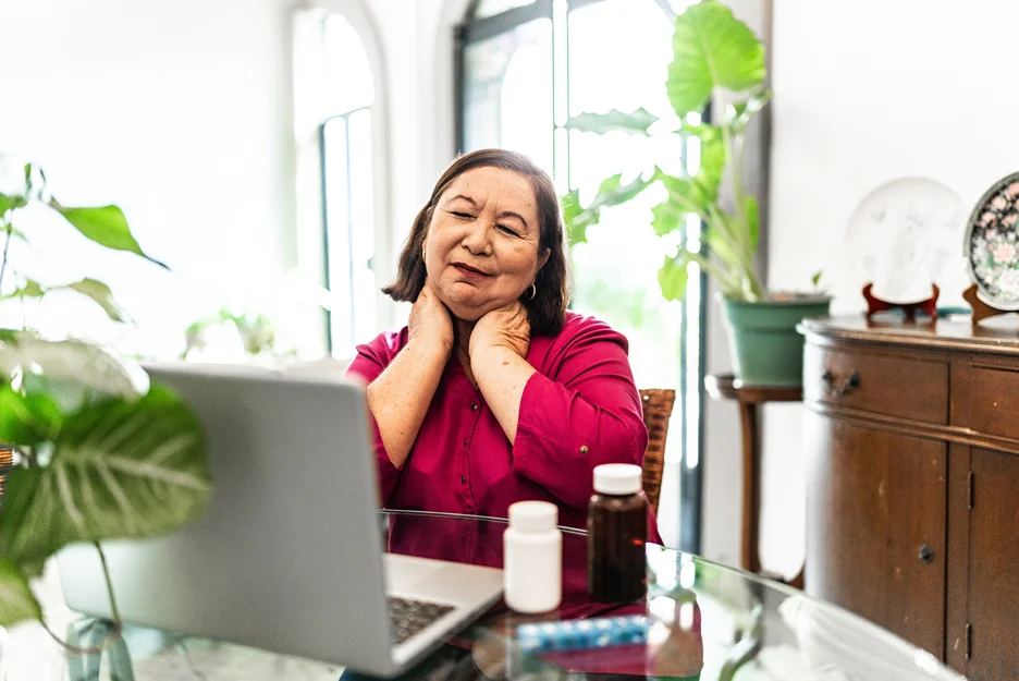 a woman has telemedicine consult on her doctor for neck pain