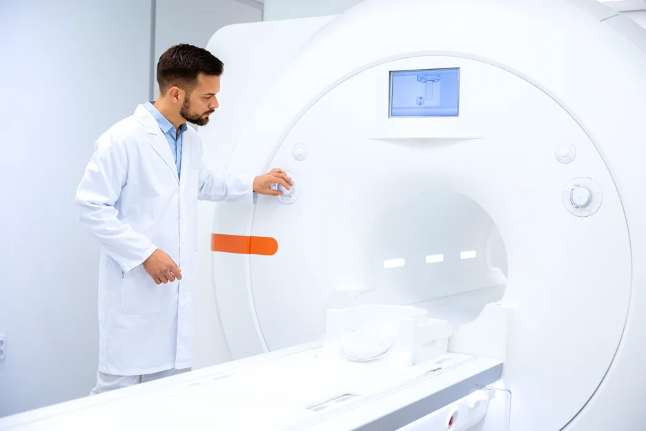 a radiologist examining MRI machine