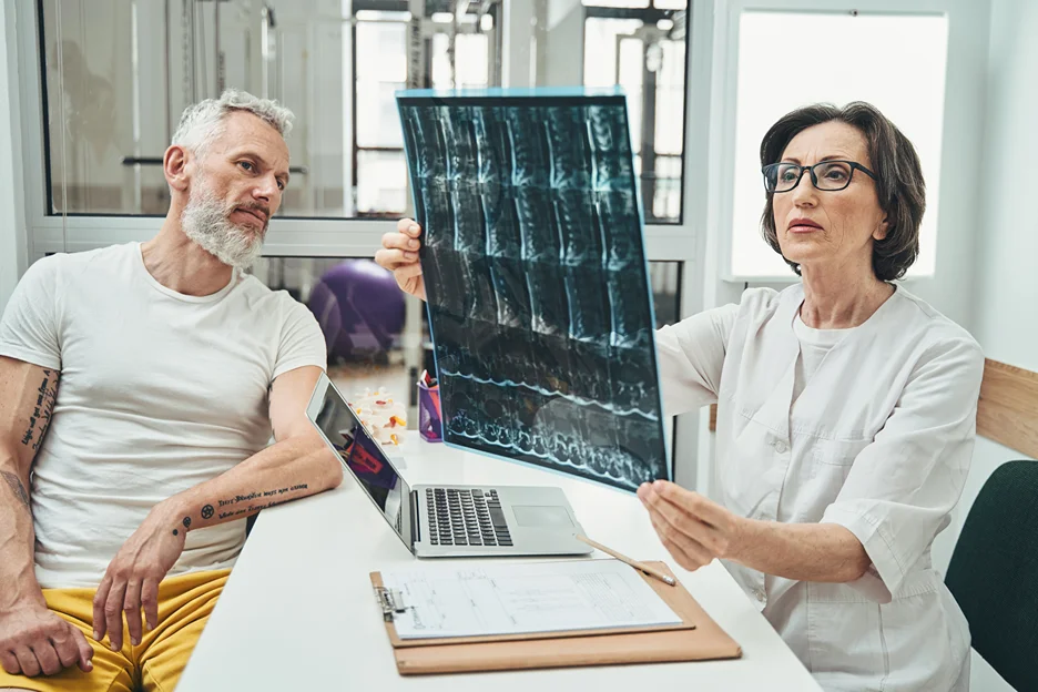 a doctor assessing the MRI scans of her male patient