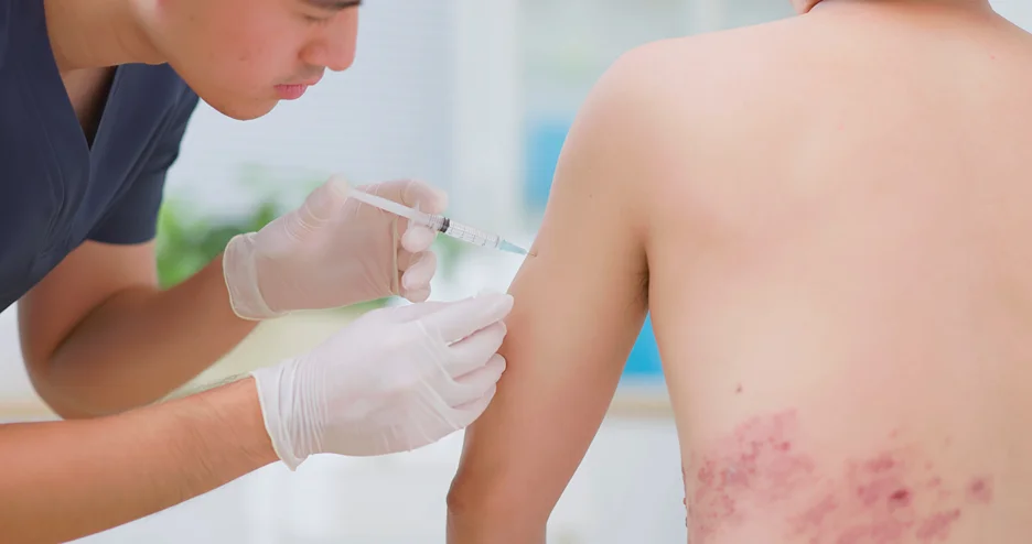 a doctor injects shingle vaccine to the patient