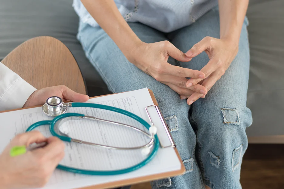 doctor and patient consult on what causes pain under right breast radiating to back